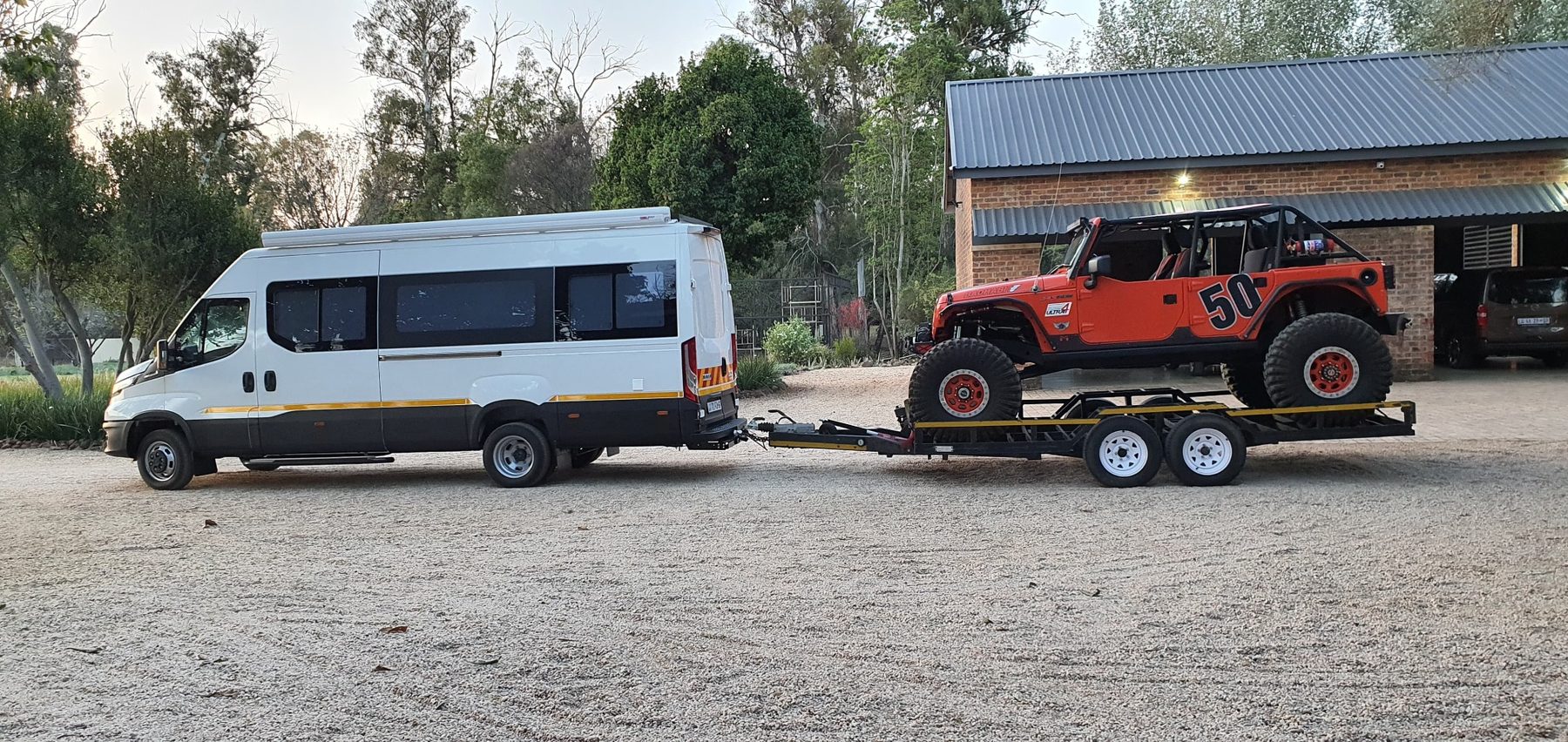 Iveco Daily motorhome towing off-road vehicle